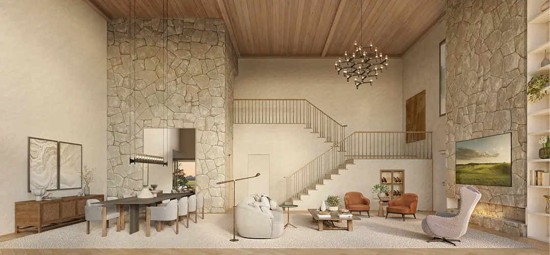 Living de casa com parede de pedra, lareira e escada aberta